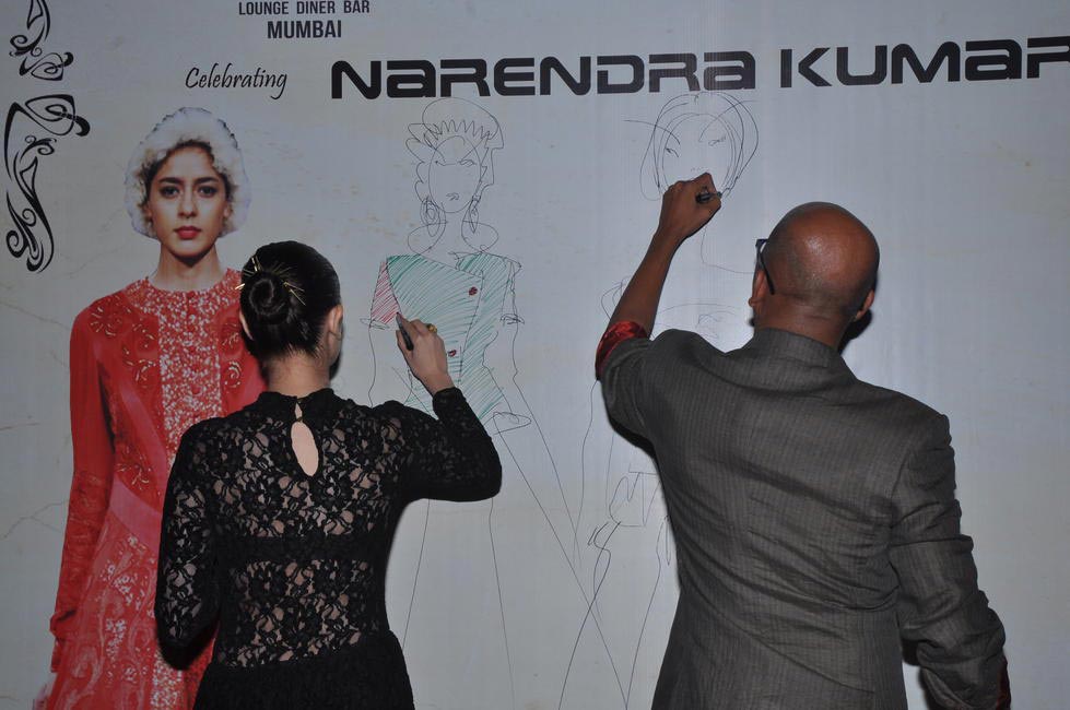 Evelyn Sharma and Narendra Kumar sketching on the Celebrity Wall