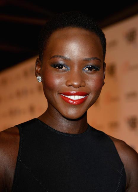 Lupita Nyong'o in Christopher Kane at London Film Festival. We love how she plays with blue eyeliners.